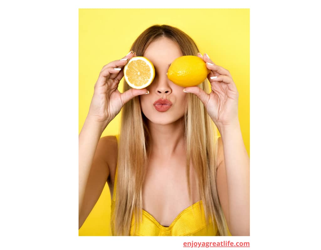 lady holding lemons up to her eyes