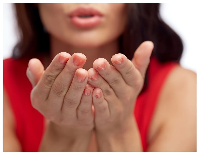 woman blowing into her hands