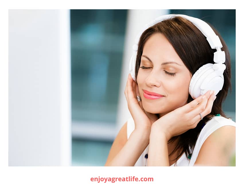 woman headphones on eyes closed listening to music
