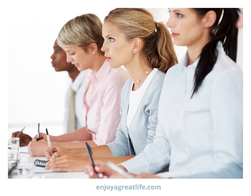 women taking notes at conference seminar