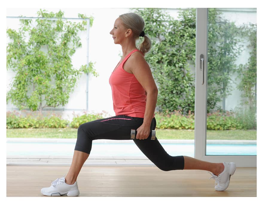 woman exercising at home with weights