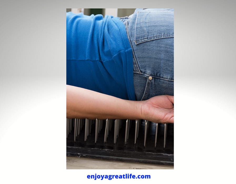 person lying on a bed of nails