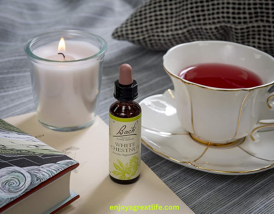 bach flower remedy white chestnut on table with a cup of tea and a candle